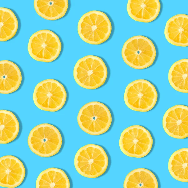 Summer fruit pattern of lemon slices on a blue background
