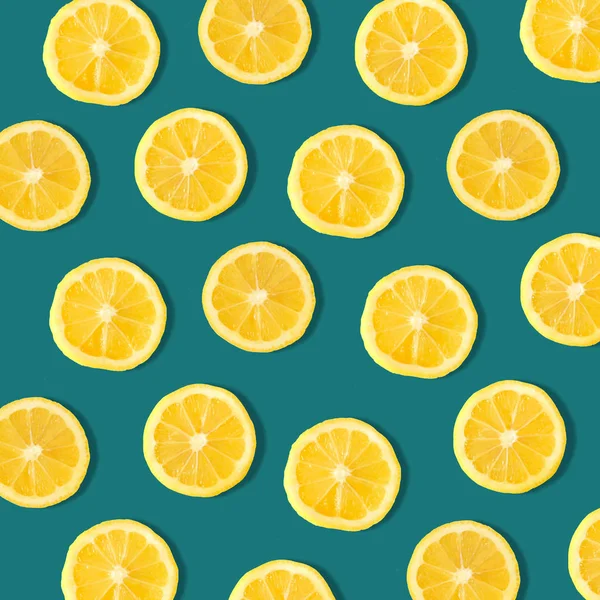 Summer fruit pattern of lemon slices on a dark blue background