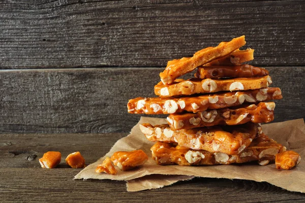 Stack Traditional Peanut Brittle Candy Pieces Rustic Wood Background — Stock Photo, Image