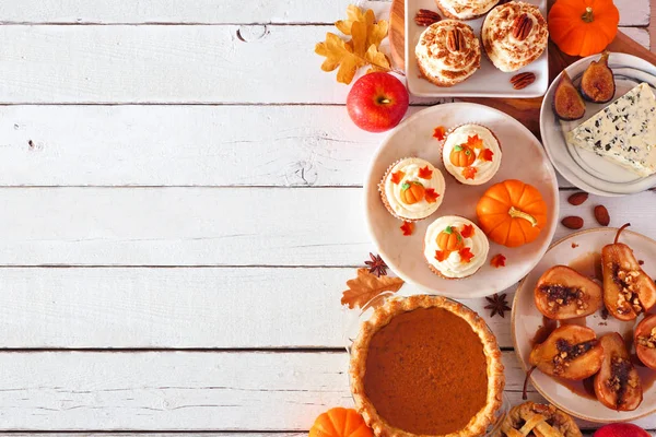 Autumn food side border. Table scene with a selection of pies, appetizers and desserts. Top view over a white wood background. Copy space.