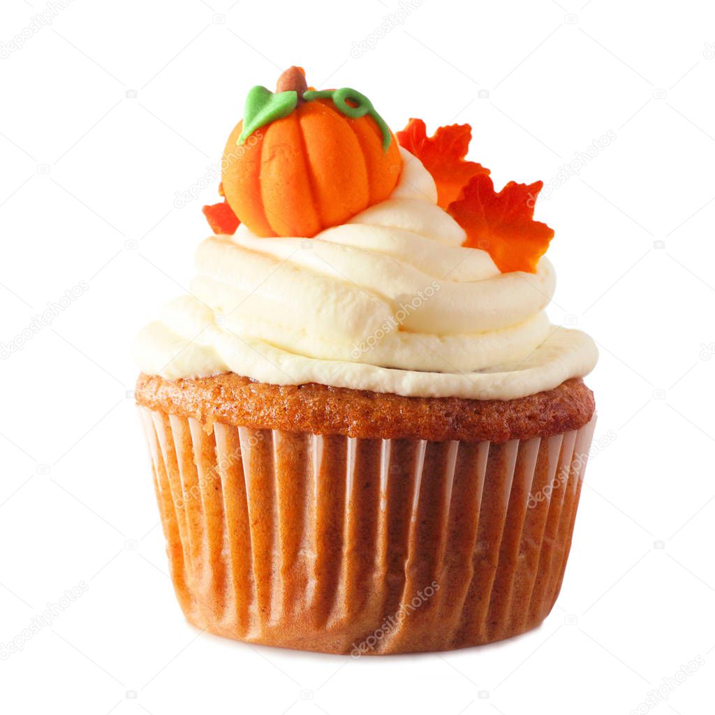 Fall pumpkin spice cupcake with creamy frosting and leaf and pumpkin toppings isolated on a white background
