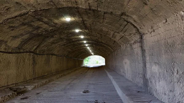 a small tunnel under the mountain with lighting. New Athos, Abkhazia