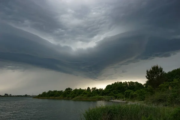 Dramatic landscape with storm clouds over the lake.