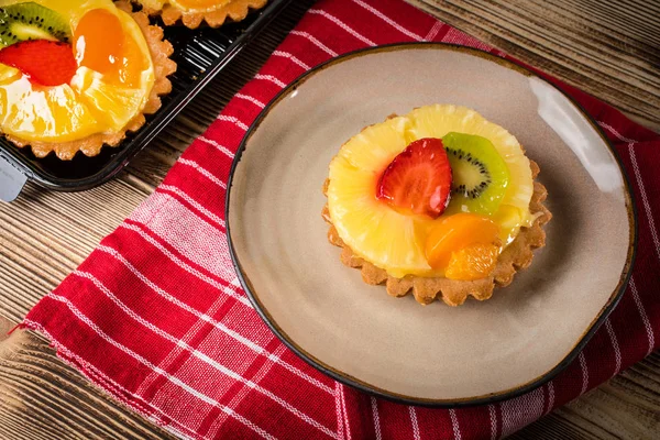 Fresh  mixed fruit tart with strawberries, pineapple and kiwi, . Selective focus.