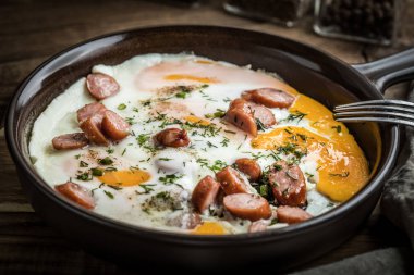 Yumurta tavaya doğranmış sosis ile pişmiş lezzetli.