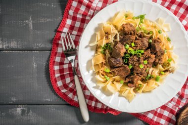 Plaka üzerinde tagliatelle makarna ile haşlanmış Dana. Üstten görünüm.
