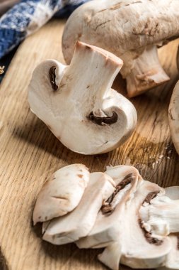 Bir kesme tahtası üzerinde ham mantar dilimlenmiş.