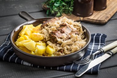 Kızarmış patatesle servis edilen lahana turşulu pirzola..