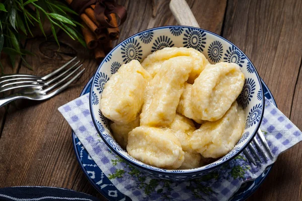 Lazy dumplings with cinnamon and sugar. Dark light.