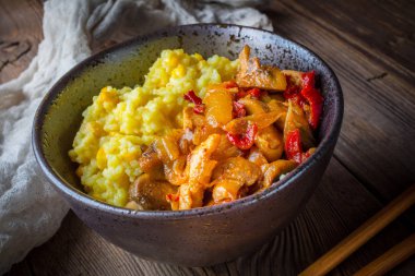 Ahşap tab tavuk ve sebze parçaları ile safran pirinç