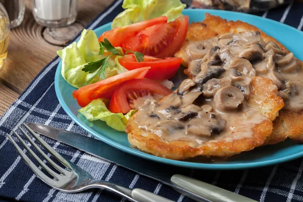 Crispy fried homemade potato pancakes with mushroom sauce. — Stock Photo, Image