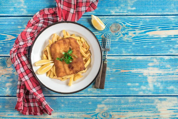 A piece of fried cod with fries on a plate. — Stock Photo, Image