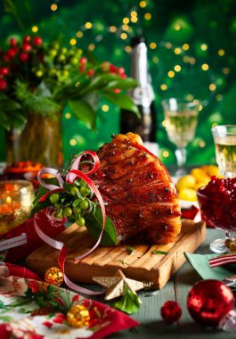 Karanfil, köpüklü şarap ve Noel akşam yemeği için geleneksel sebze yemekleri ile sırlı kızarmış jambon.