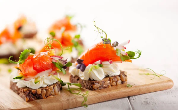 Mini canapes with smoked salmon — Stock Photo, Image