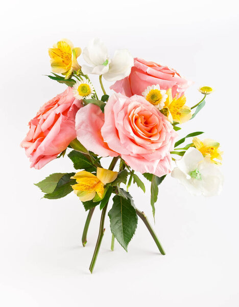 Beautiful bunch with coral roses with green leaves on white back