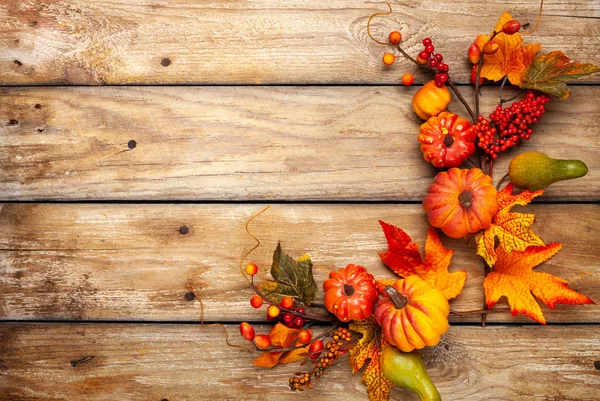 Sváteční podzimní výzdoba z dýně, bobulí a listí na rezavé — Stock fotografie