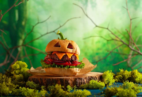 Halloween party burger in shape of scary pumpkin  on  wooden boa — Stock Photo, Image
