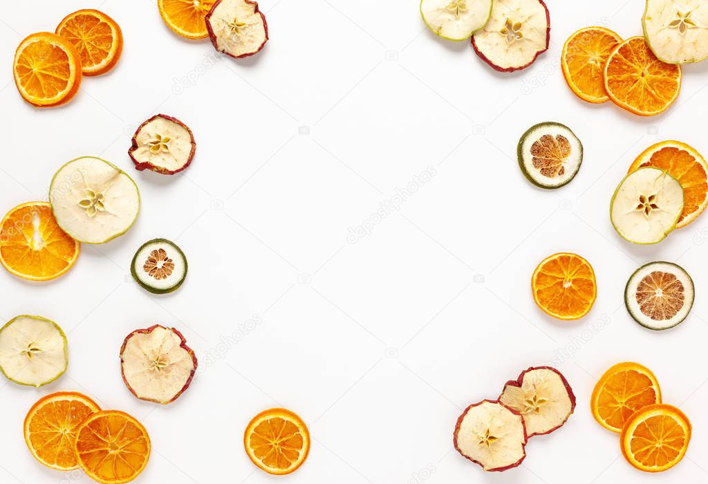 Christmas composition with dried oranges and apples slices on wh