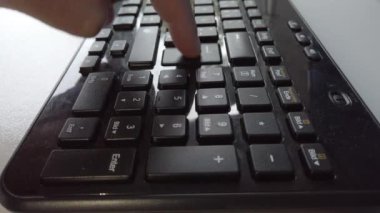 Man pressing the Enter key in a keyboard