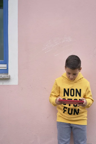 Olhos verdes menino surfar internet com tablet escondido na rua — Fotografia de Stock