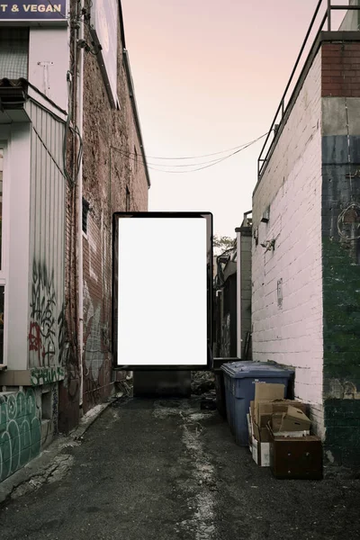 Poster billboard on city dirty alley background .Blank advertising billboard mockup in the street