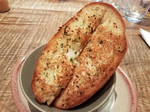 slices of seasoned garlic bread in a bowl