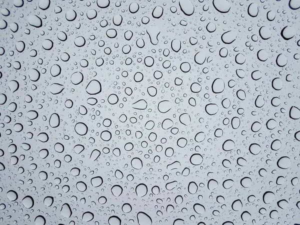 Капли круговой воды или капли на стеклянное окно от дождя — стоковое фото