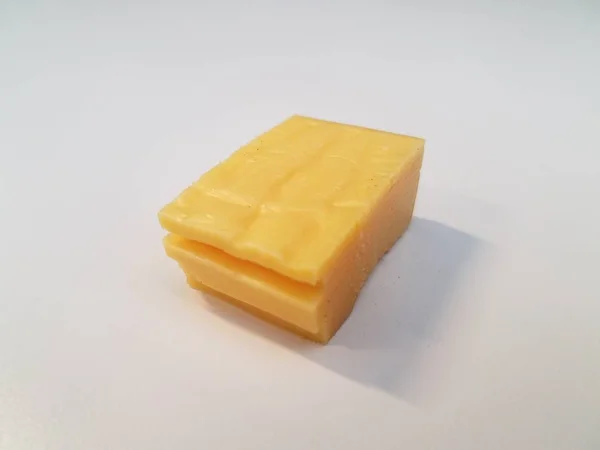 Stack of yellow cheese on white surface or table — Stock Photo, Image