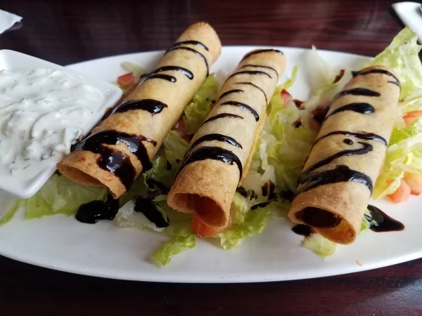 crispy filled rolls appetizer with yogurt dipping sauce