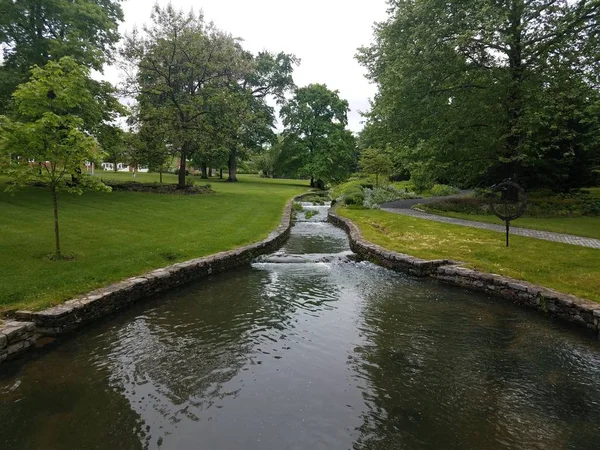 Green grass with flowing river or stream or creek — Stock Photo, Image