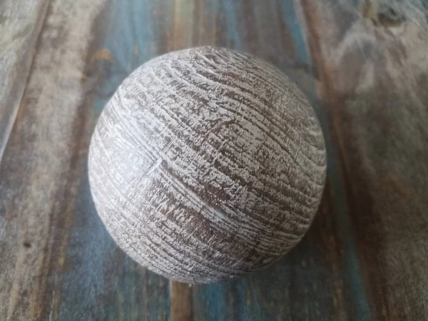 brown metal ball on brown wooden table