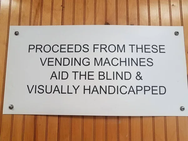 Proceeds from vending machines aid the blind sign on wall — Stock Photo, Image
