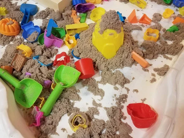 Table with sand and plastic tools for kids to play with — Stock Photo, Image