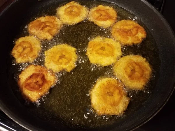 Pisang plantain tostones Puerto Rico food cook in oil in friying pan — Stok Foto