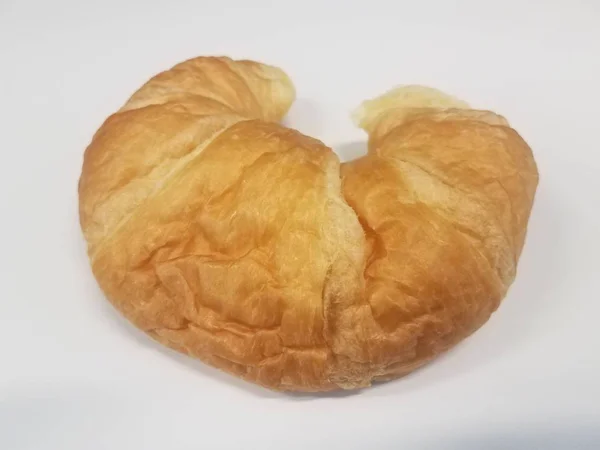 Fluffy croissant bread snack on white surface — Stock Photo, Image