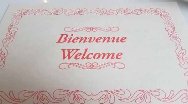 Placemat with bienvenue or welcome in French on table — Stock Photo, Image