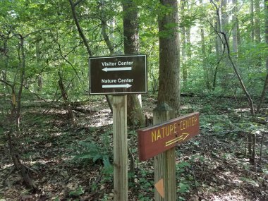 nature center and visitor center signs in the forest