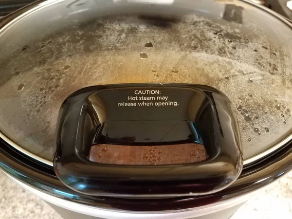 Caution hot steam may release when opening sign on pot — 스톡 사진