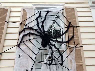 house with window and black spider Halloween decoration