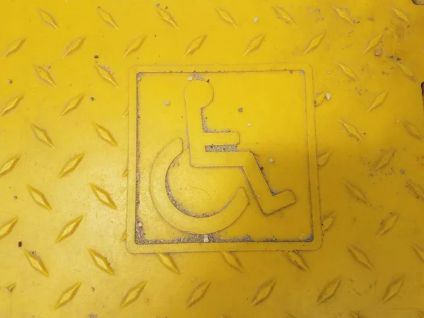 Gelbes Rollstuhlfahrersymbol Auf Rauer Oberfläche — Stockfoto