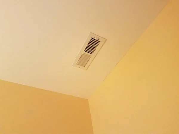 vent on the ceiling in a corner of a room