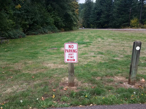 Red White Parking Any Time Grass Sign Wood Post — Stock Photo, Image