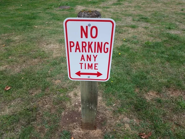 Red White Parking Any Time Grass Sign Wood Post — Stock Photo, Image