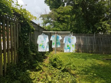 Arka bahçede kuruması için boyanmış beyaz gömlekler.