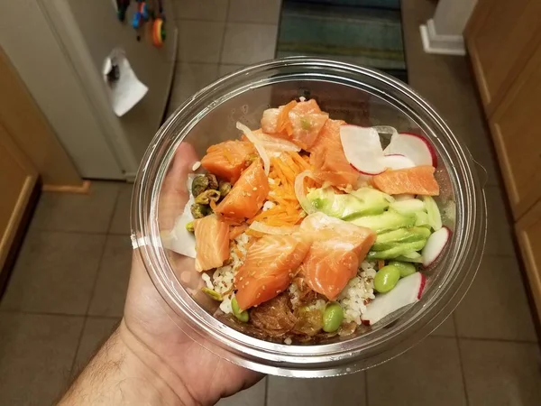 Hand Holding Bowl Salmon Sushi Rice Avocado Radish Kitchen — Stock Photo, Image