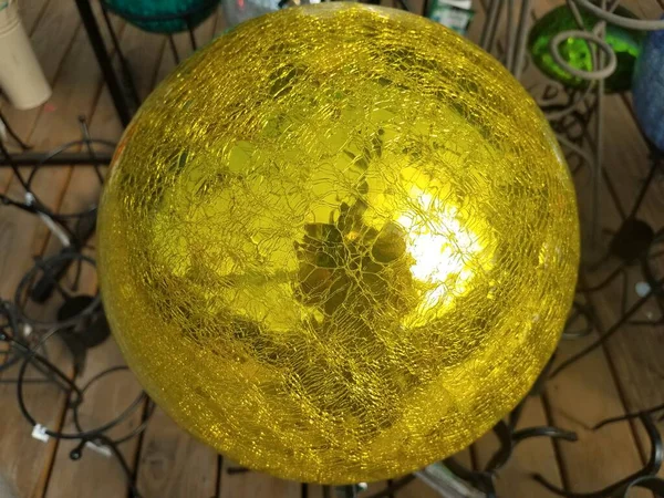 a reflective yellow or gold sphere or ball