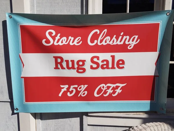 red and white store closing rug sale 75 percent off banner sign