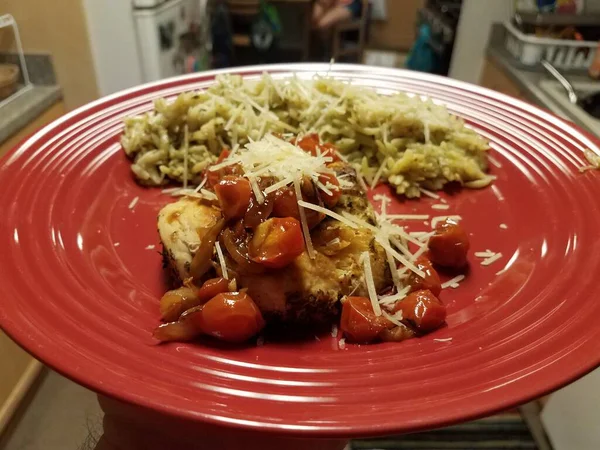 접시에 닭고기와 토마토 그리고 주방에서 파스타를 곁들인 — 스톡 사진