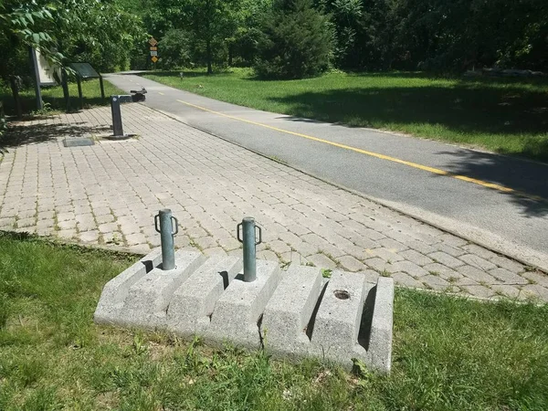 a bike rack and asphalt bike or walking trail