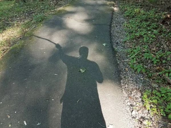 Shadow Man Swinging Stick Black Asphalt — Stock Photo, Image